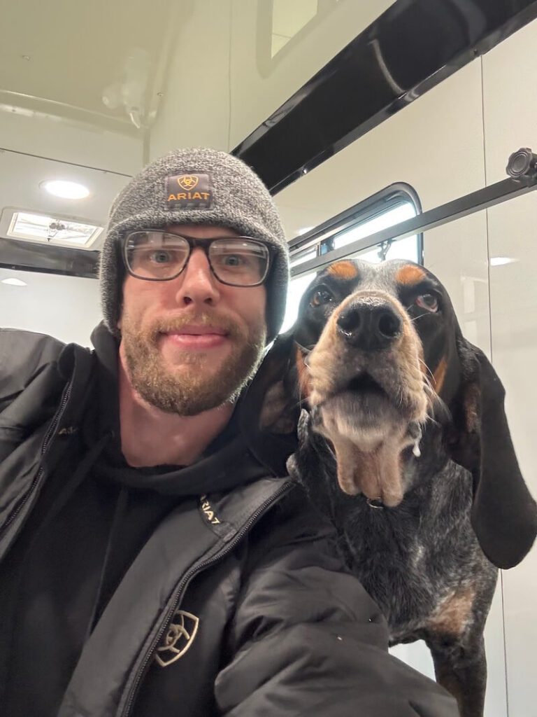 Steven posing with a happy canine customer at The Groomin' Cowboy Mobile Saloon