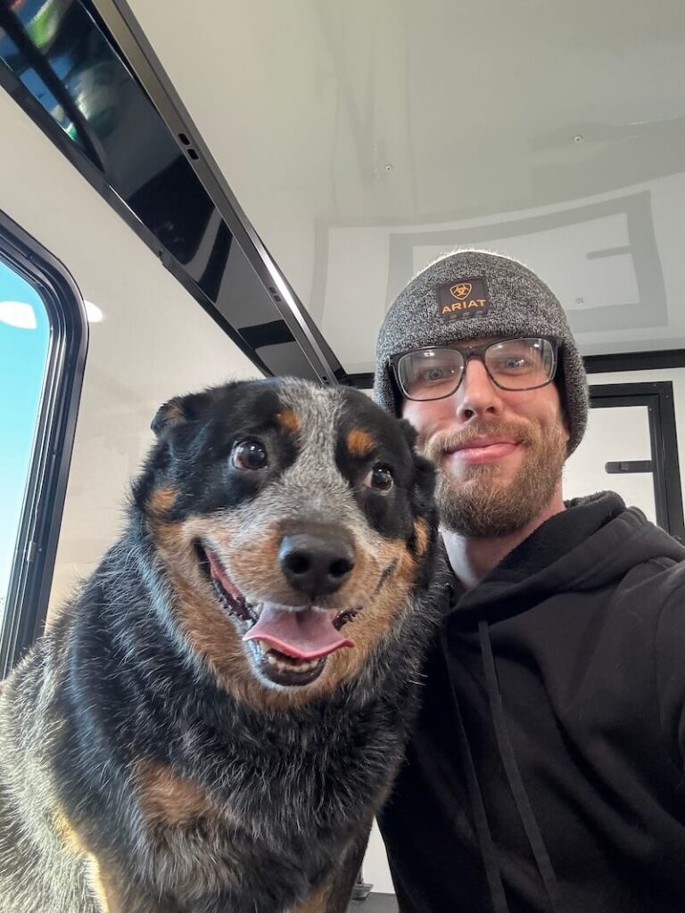Steven posing with a happy canine customer at The Groomin' Cowboy Mobile Saloon