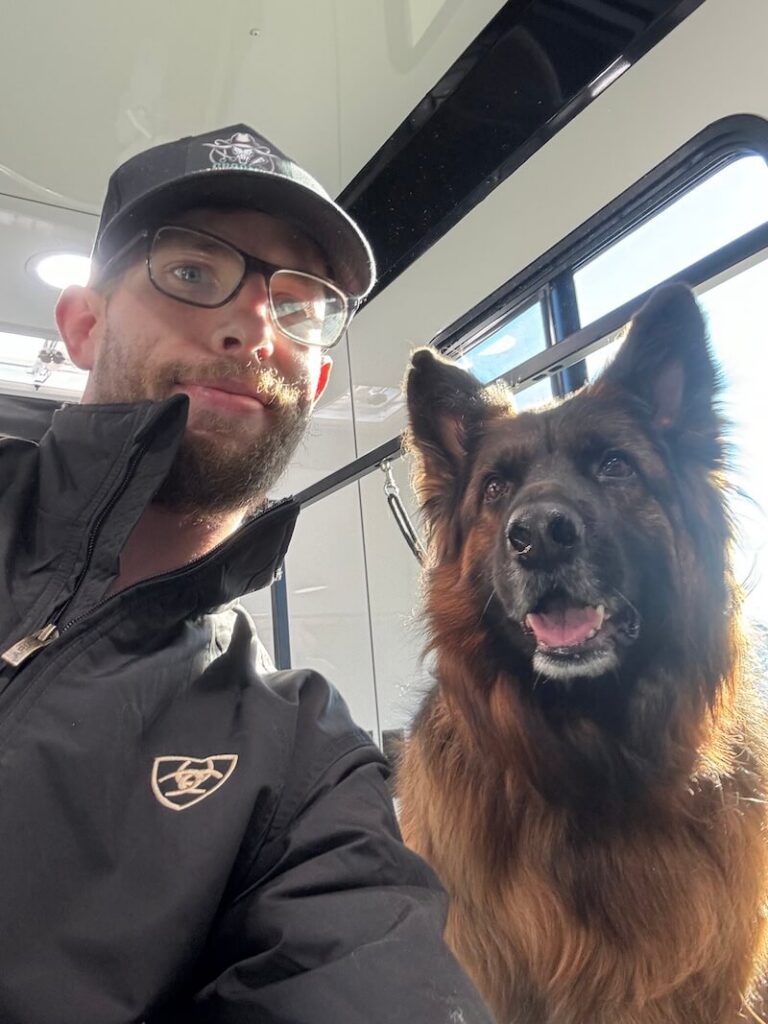 Steven posing with a happy canine customer at The Groomin' Cowboy Mobile Saloon
