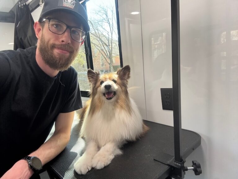 Steven posing with a happy canine customer at The Groomin' Cowboy Mobile Saloon